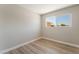 This clean, empty bedroom features wood floors and a large window at 5245 Hillman Ave, Las Vegas, NV 89142