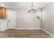 Inviting dining area with modern light fixture and wood-look flooring at 5245 Hillman Ave, Las Vegas, NV 89142