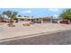 Charming single-story home with a gravel yard, mature trees, and an attached two-car garage at 5245 Hillman Ave, Las Vegas, NV 89142