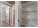 Hallway with white walls, wood-look floors, and doorway to the bathroom at 5245 Hillman Ave, Las Vegas, NV 89142