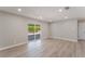 Spacious living room with recessed lighting, wood laminate flooring, and backyard access at 5245 Hillman Ave, Las Vegas, NV 89142