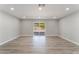 Open living area with recessed lighting, modern floors, and sliding doors to the backyard at 5245 Hillman Ave, Las Vegas, NV 89142