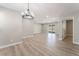 Large living room with recessed lighting, wood-look floors, and sliding glass door to the backyard at 5245 Hillman Ave, Las Vegas, NV 89142