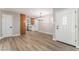 Inviting open-concept living space with laminate flooring, a modern chandelier and a view of kitchen at 5245 Hillman Ave, Las Vegas, NV 89142