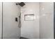 Beautifully tiled shower with black hardware including rainfall shower head and shower niche at 5245 Hillman Ave, Las Vegas, NV 89142