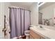 Bathroom with tile floor, mirror, and shower with a gray curtain at 5401 Bugle Way # 103, Las Vegas, NV 89108