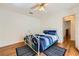 Bedroom with hardwood floors, ceiling fan, and a comfortable bed and rug at 5401 Bugle Way # 103, Las Vegas, NV 89108