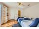 Sun-filled bedroom with hardwood floors, ceiling fan, and built-in shelving at 5401 Bugle Way # 103, Las Vegas, NV 89108