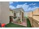 Private patio with a pergola, grill, and artificial turf, perfect for outdoor entertaining and relaxation at 5401 Bugle Way # 103, Las Vegas, NV 89108
