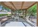 Community pergola offers a peaceful setting for relaxation, surrounded by lush greenery and mature trees at 5401 Bugle Way # 103, Las Vegas, NV 89108