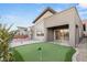 Beautiful backyard featuring a putting green, basketball court, and modern architecture at 6056 Willow Rock St, Las Vegas, NV 89135