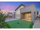 Spacious backyard with a putting green, basketball court, and sliding glass doors that open to the home's interior at 6056 Willow Rock St, Las Vegas, NV 89135