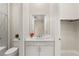 This bathroom features a single sink vanity, a large mirror, and a shower-tub combo with glass door at 6056 Willow Rock St, Las Vegas, NV 89135