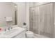 Clean bathroom featuring a single sink vanity with a modern faucet and framed mirror and glass enclosed shower at 6056 Willow Rock St, Las Vegas, NV 89135