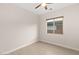 This bedroom has wood-look tile flooring, a ceiling fan, and a double-hung window that lets in natural light at 6056 Willow Rock St, Las Vegas, NV 89135