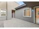 Private courtyard with a tiled floor and stucco walls, offering a tranquil outdoor space for relaxation and reflection at 6056 Willow Rock St, Las Vegas, NV 89135