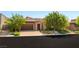 Well-maintained exterior with a two-car garage and desert landscaping at 6056 Willow Rock St, Las Vegas, NV 89135