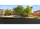 Charming home exterior with a well-manicured lawn and mature trees at 6056 Willow Rock St, Las Vegas, NV 89135