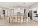 Spacious kitchen with a large island, modern appliances, sleek cabinetry and stylish barstool seating at 6056 Willow Rock St, Las Vegas, NV 89135