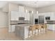Well-appointed kitchen boasts stainless appliances, a center island with barstool seating, and ample counter space at 6056 Willow Rock St, Las Vegas, NV 89135