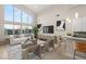 Bright living room featuring high ceilings, large windows and neutral modern decor with hardwood floors and stylish furnishings at 6056 Willow Rock St, Las Vegas, NV 89135
