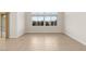 Bright living room featuring tile floors and large windows offering ample natural light at 6056 Willow Rock St, Las Vegas, NV 89135