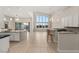 Bright living space features an open floor plan, a modern kitchen, and large windows that offer plenty of natural light at 6056 Willow Rock St, Las Vegas, NV 89135