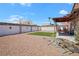 Expansive backyard with low-maintenance rock landscaping and a covered patio at 619 Zalataia Way, North Las Vegas, NV 89031
