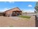 The backyard features gravel, a patio, and a grassy area, perfect for relaxing and entertaining outdoors at 619 Zalataia Way, North Las Vegas, NV 89031