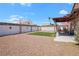 Spacious backyard featuring a mix of rock, artificial turf, and a covered patio area at 619 Zalataia Way, North Las Vegas, NV 89031