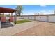 This backyard provides a private outdoor space with gravel, a patio, and a grassy area for relaxation and entertainment at 619 Zalataia Way, North Las Vegas, NV 89031