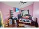 Bright bedroom with pink walls, a decorative bed, and a ceiling fan at 619 Zalataia Way, North Las Vegas, NV 89031