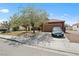 Charming single-story home with a well-maintained lawn, mature trees, and a two-car garage, situated in a friendly neighborhood at 619 Zalataia Way, North Las Vegas, NV 89031