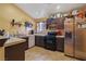 Well-lit functional kitchen with ample cabinet space, updated appliances, and a breakfast bar for casual dining at 619 Zalataia Way, North Las Vegas, NV 89031