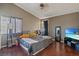 Comfortable main bedroom features hardwood floors and neutral tones at 619 Zalataia Way, North Las Vegas, NV 89031