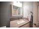 Bathroom featuring a sink, faucet, decorative mirror, and a towel rack at 6417 Fisher Ave, Las Vegas, NV 89130