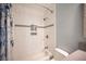 A bathroom with a shower and white tile with a built-in soap nook at 6417 Fisher Ave, Las Vegas, NV 89130