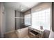 Contemporary bathroom featuring a glass shower enclosure with a bench and a vanity area with great natural light at 6417 Fisher Ave, Las Vegas, NV 89130