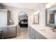 Bathroom featuring double sinks, under cabinet storage and an arched entrance to the primary bedroom at 6417 Fisher Ave, Las Vegas, NV 89130
