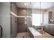 Upgraded bathroom showcases a tiled shower with bench seating, a rain shower head, and a separate vanity area at 6417 Fisher Ave, Las Vegas, NV 89130