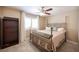 A relaxing bedroom with a decorative metal bed frame, matching furniture, and a shuttered window at 6417 Fisher Ave, Las Vegas, NV 89130