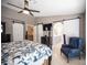 Bedroom featuring a ceiling fan, sliding barn doors, and a comfortable bed with decorative bedding and an ensuite bath at 6417 Fisher Ave, Las Vegas, NV 89130