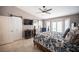 Bedroom showcases a ceiling fan, sliding barn door, window, and a comfortable bed with decorative bedding at 6417 Fisher Ave, Las Vegas, NV 89130