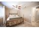 A relaxing bedroom with a decorative metal bed frame, matching furniture, and a shuttered window at 6417 Fisher Ave, Las Vegas, NV 89130