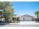 Charming single-story home with a well-manicured lawn, mature tree, and a two-car garage at 6417 Fisher Ave, Las Vegas, NV 89130