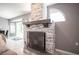 Stone fireplace in living room with access to an outdoor area and contemporary decor at 6417 Fisher Ave, Las Vegas, NV 89130