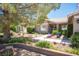Beautiful front yard with lush plants, flowers, and an inviting walkway leading to the front door at 6417 Fisher Ave, Las Vegas, NV 89130