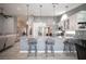 Bright kitchen with stainless steel appliances, a large island with seating, and modern pendant lighting at 6417 Fisher Ave, Las Vegas, NV 89130