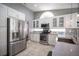 Modern kitchen features stainless steel appliances, stylish backsplash, white cabinets, and updated fixtures at 6417 Fisher Ave, Las Vegas, NV 89130