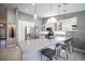 Bright open kitchen with high ceilings, white cabinets, stainless steel appliances, and a large quartz countertop island at 6417 Fisher Ave, Las Vegas, NV 89130